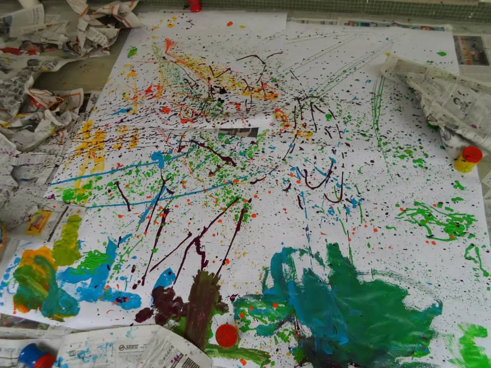 Large abstract preschool painting with colourful drips and brush marks.