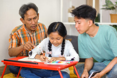 father-brother-telling-little-girl-doing-homework-table-while-sitting-floor father-brother-telling-little-girl-doing-homework-table-while-sitting-floor